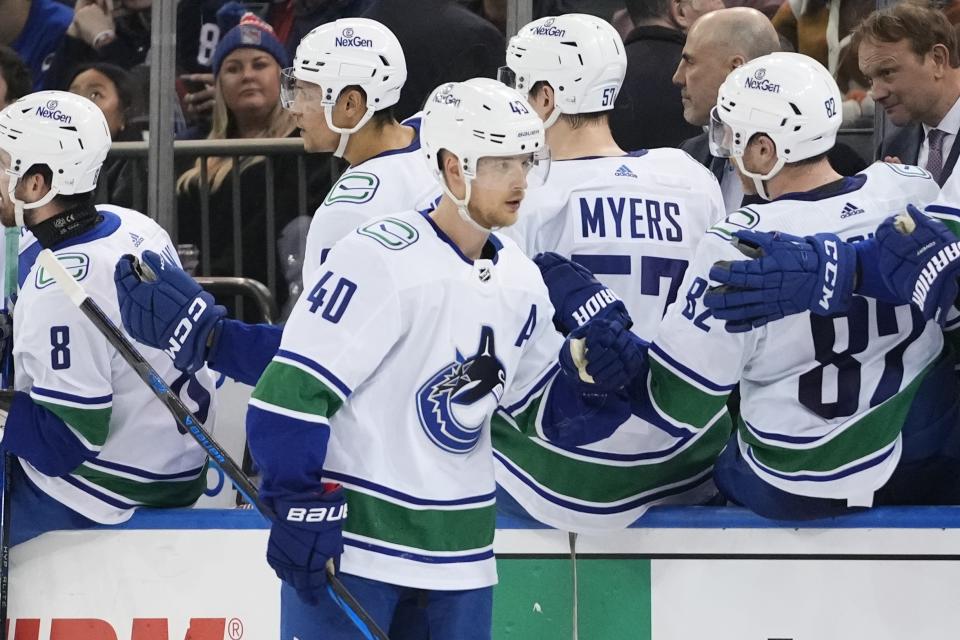 Vancouver Canucks' Elias Pettersson (40) celebrates with teammates after scoring a goal during the second period of an NHL hockey game against the New York Rangers Monday, Jan. 8, 2024, in New York. (AP Photo/Frank Franklin II)