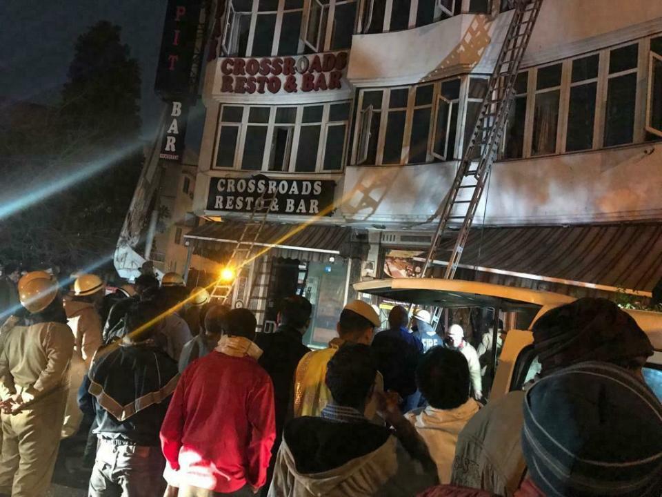 In this photo provided by Sivanand Chand, a hotel guest who was rescued, firefighters rescue people during an early morning fire at the Arpit Palace Hotel in the Karol Bagh neighborhood of New Delhi, India, Tuesday, Feb.12, 2019. More than a dozen people were killed. (Sivanand Chand via AP)