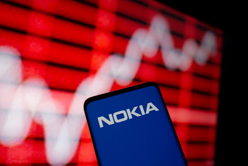 FILE PHOTO: The Nokia logo is seen on a smartphone in front of a displayed stock graph in this illustration