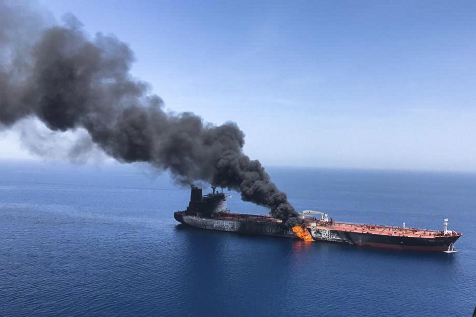 FILE - In this Thursday, June 13, 2019 file photo, an oil tanker is on fire in the sea of Oman. For decades considered a U.S. national security priority, the Persian Gulf remains home to tens of thousands of American troops spread across sprawling bases protecting crucial routes for global energy supplies. But while U.S.-Iran tensions in the Gulf appeared close to sparking a global conflagration this summer, attention now rapidly has shifted to Syria. (AP Photo/ISNA, File)