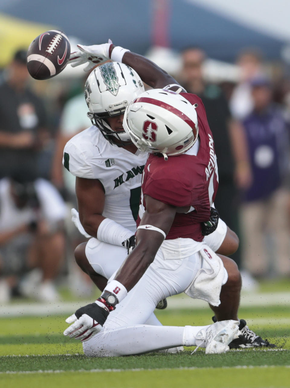 Hawaii defensive back Cam Stone, left, breaks up a pass intended for Stanford wide receiver Mudia Reuben during the first half of an NCAA college football game Friday, Sept. 1, 2023, in Honolulu. (Jamm Aquino/Honolulu Star-Advertiser via AP)