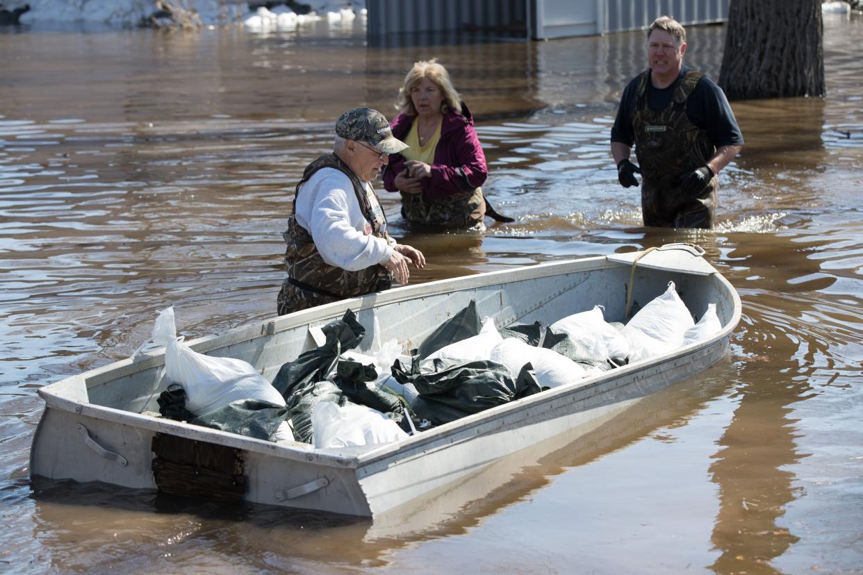 A man moves a boat full of sandbags to help with the flooding in Constance Bay, west of Ottawa, Ontario, on April 28, 2019. - More than 5,000 people were told to quickly leave their homes near Montreal late Saturday and early Sunday after floodwaters breached a dike in rain-soaked eastern Canada. According to the latest government data, nearly 8,000 people have been forced by rising waters from their homes in Quebec, and about 6,000 homes have been flooded -- topping the 2017 toll during what was then the area's worst flooding in a half-century. ast week, both Montreal and the capital Ottawa declared states of emergency. In Fredericton, New Brunswick, crews have been busy hauling away driftwood and debris as waters start to recede. (Photo by Lars Hagberg / AFP)        (Photo credit should read LARS HAGBERG/AFP via Getty Images)