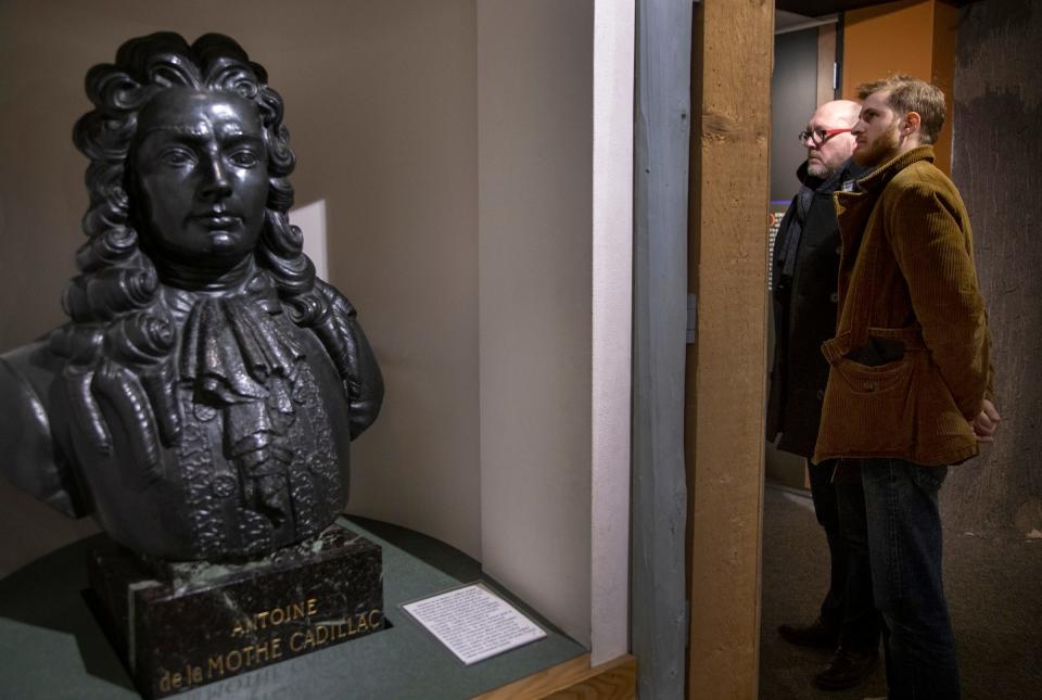 Descendants of Antoine de la Mothe Cadillac, the founder of Detroit, take a tour of the city in March 2020 that included the Detroit Historical Museum. Francois Laumet, 59, who flew in from France, looks at a map of Detroit with his son Jean Laumet, 30, of Toronto next to a bust of Cadillac in the museum.