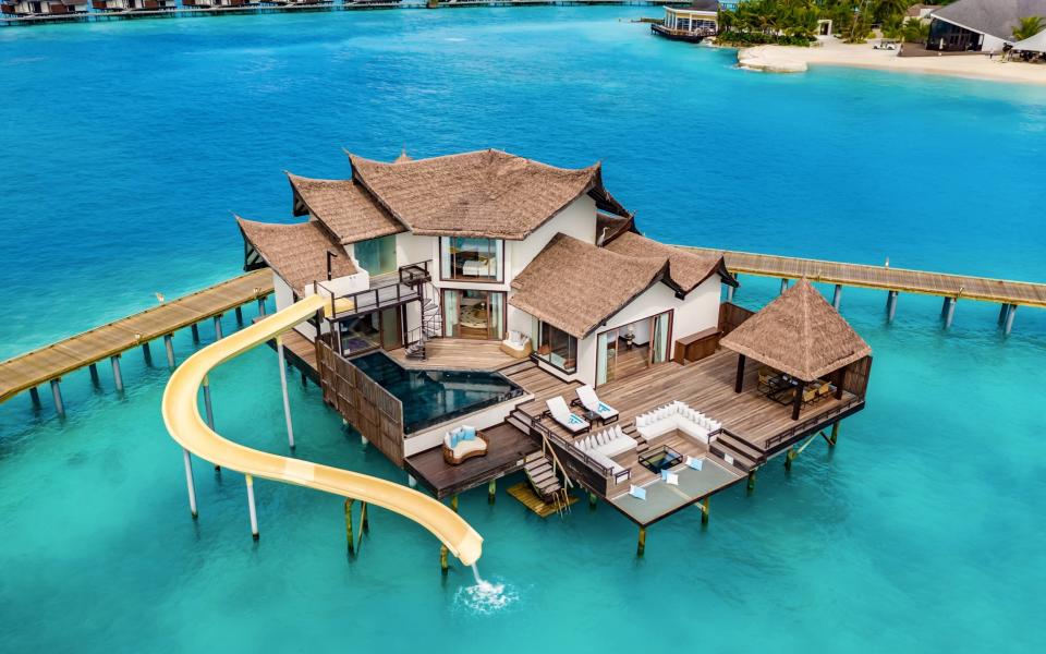 Stay in one of the over-water villas at  Ozen Reserve Bolifush on the Maldives and you can slide right into the Indian Ocean