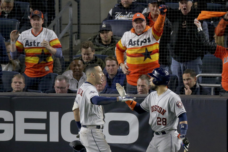 Houston Astros shortstop Carlos Correa (1) celebrates with Robinson Chirinos (28) after hitting a three-run home run against the New York Yankees during the sixth inning of Game 4 of baseball's American League Championship Series, Thursday, Oct. 17, 2019, in New York. (AP Photo/Seth Wenig)