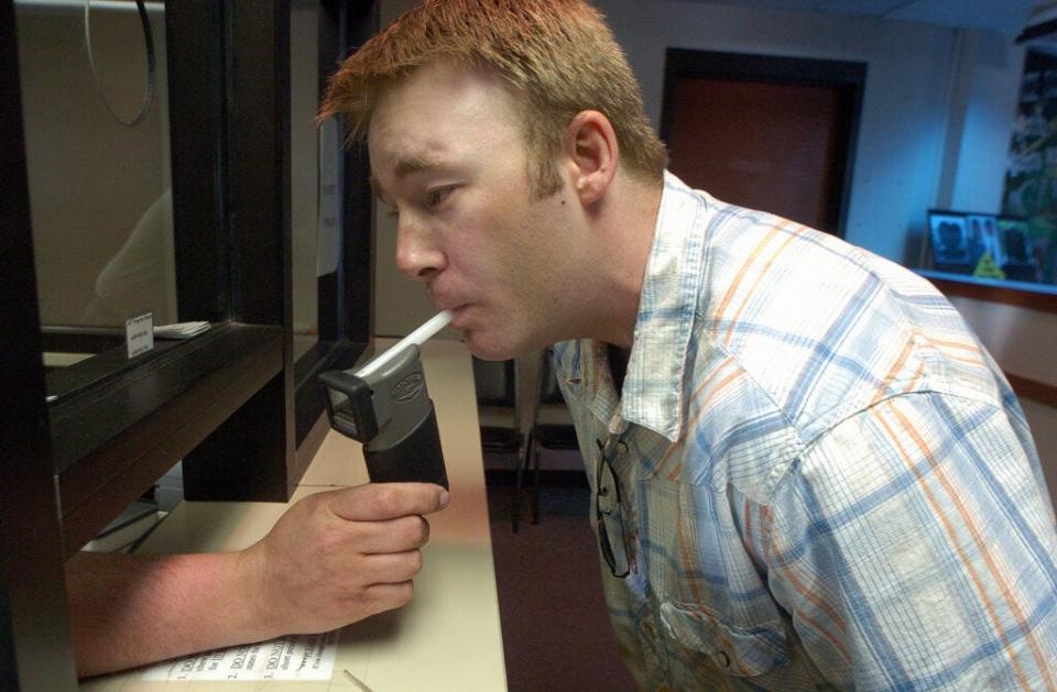 David Whitesock, shown in this 2006 photo taking a breathalyzer test, was tested twice a day for 947 days after receiving his fifth DUI. He now runs his own business assisting in addiction recovery.
