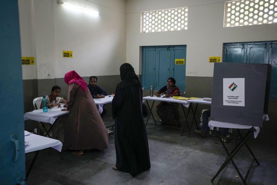 Women arrive to cast their vote at a polling station during the fourth phase of general election in Hyderabad, India, Monday, May 13, 2024. (AP Photo/Mahesh Kumar A.)