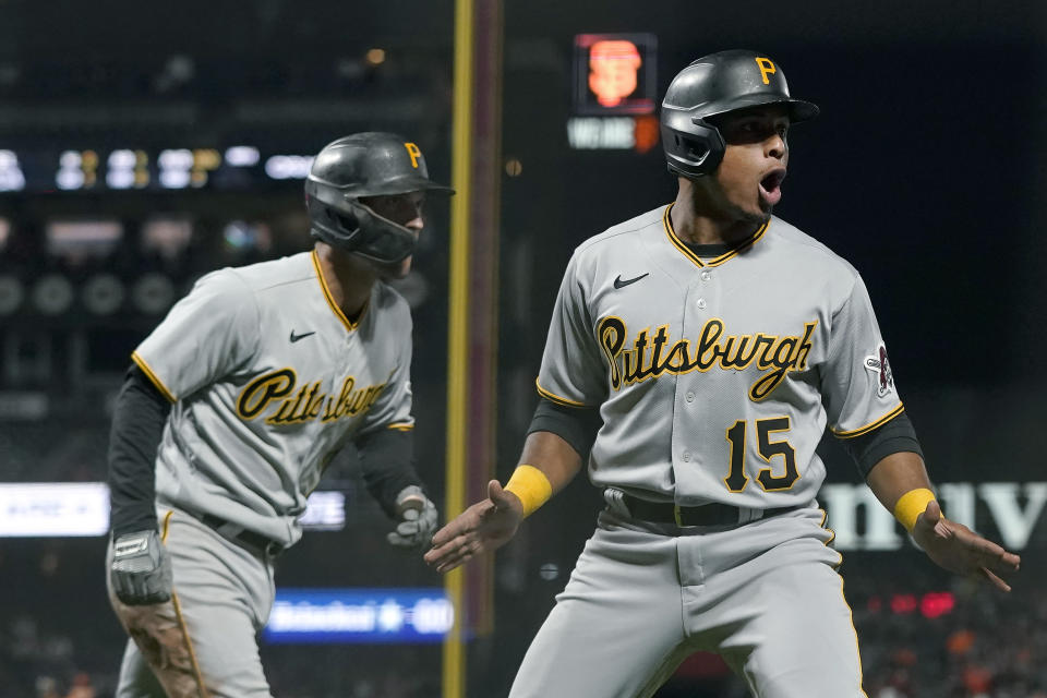 Pittsburgh Pirates' Adam Frazier, left, and Wilmer Difo (15) celebrate after both scored against the San Francisco Giants during the seventh inning of a baseball game in San Francisco, Friday, July 23, 2021. (AP Photo/Jeff Chiu)