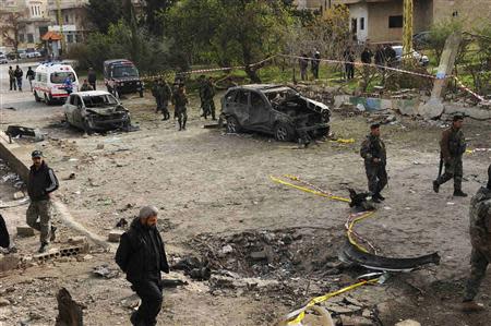 Lebanese army soldiers and residents gather at the site of Sunday's explosion in Nabi Osmane in the Bekaa Valley March 17, 2014. REUTERS/Hassan Abdallah