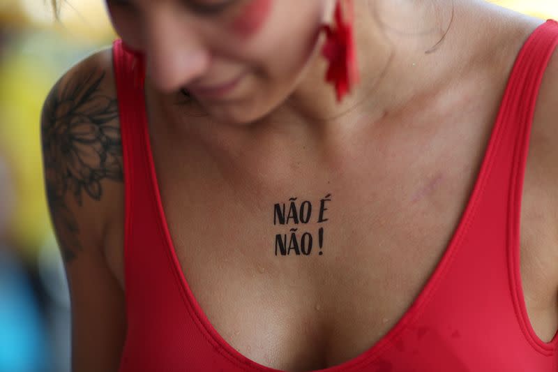 A reveller is seen with a temporary tattoo that reads “No means No” during a carnival block party in Sao Paulo