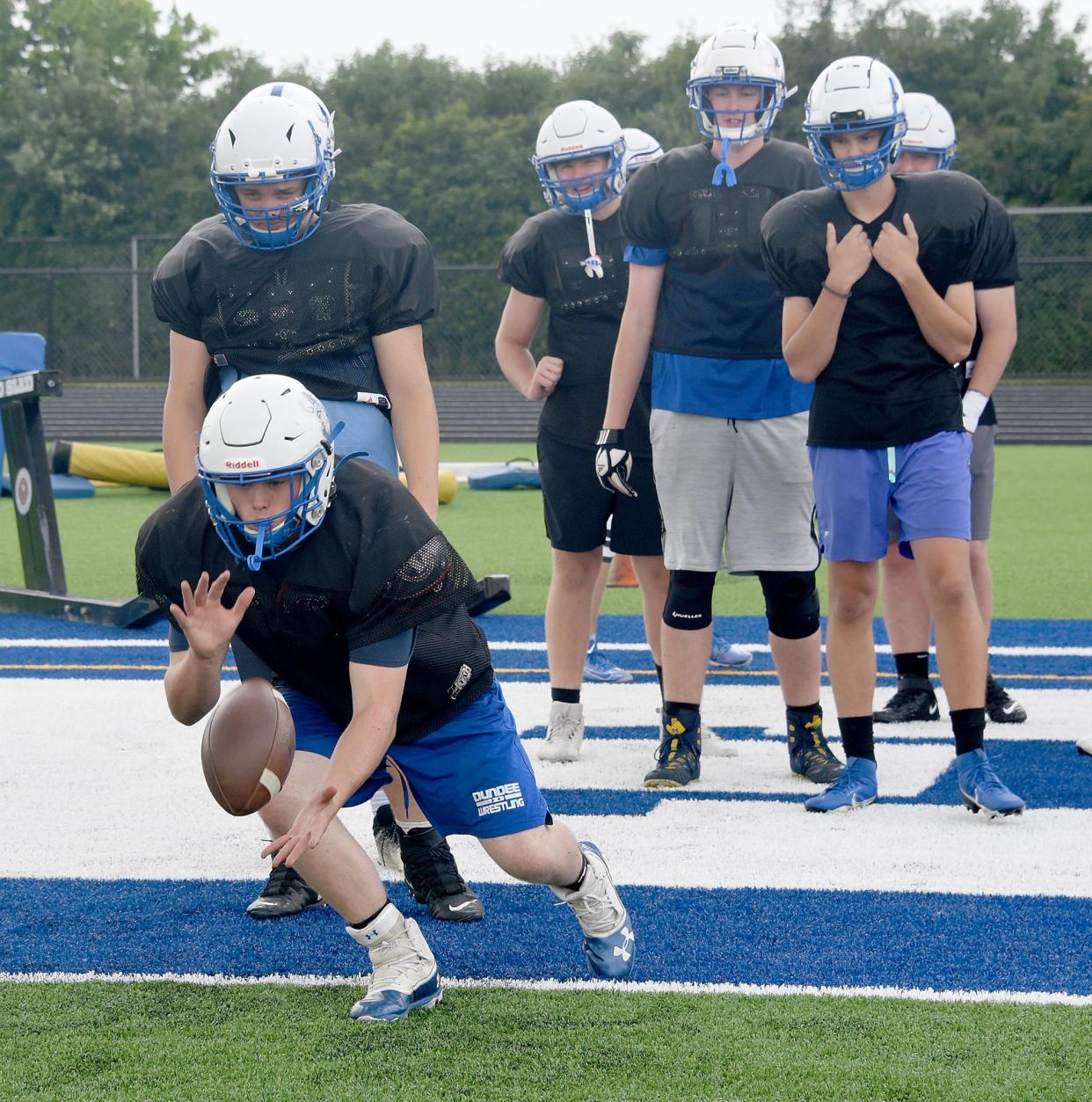 Dundee lineman Aidan Massingill practices recovering the ball as it bounces off the new turf field recently inside the new John D. Craig and Family Athletic Complex.