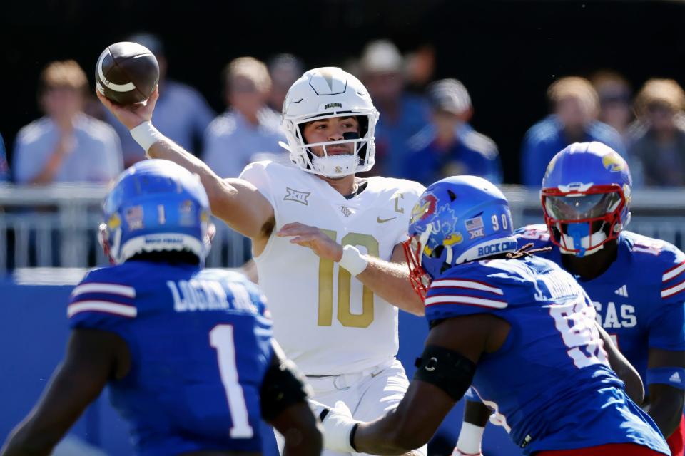 Central Florida quarterback John Rhys Plumlee (10) throws a pass as he is pressured by Kansas defenders during the first half of an NCAA college football game Saturday, Oct. 7, 2023, in Lawrence, Kan. (AP Photo/Colin E. Braley)