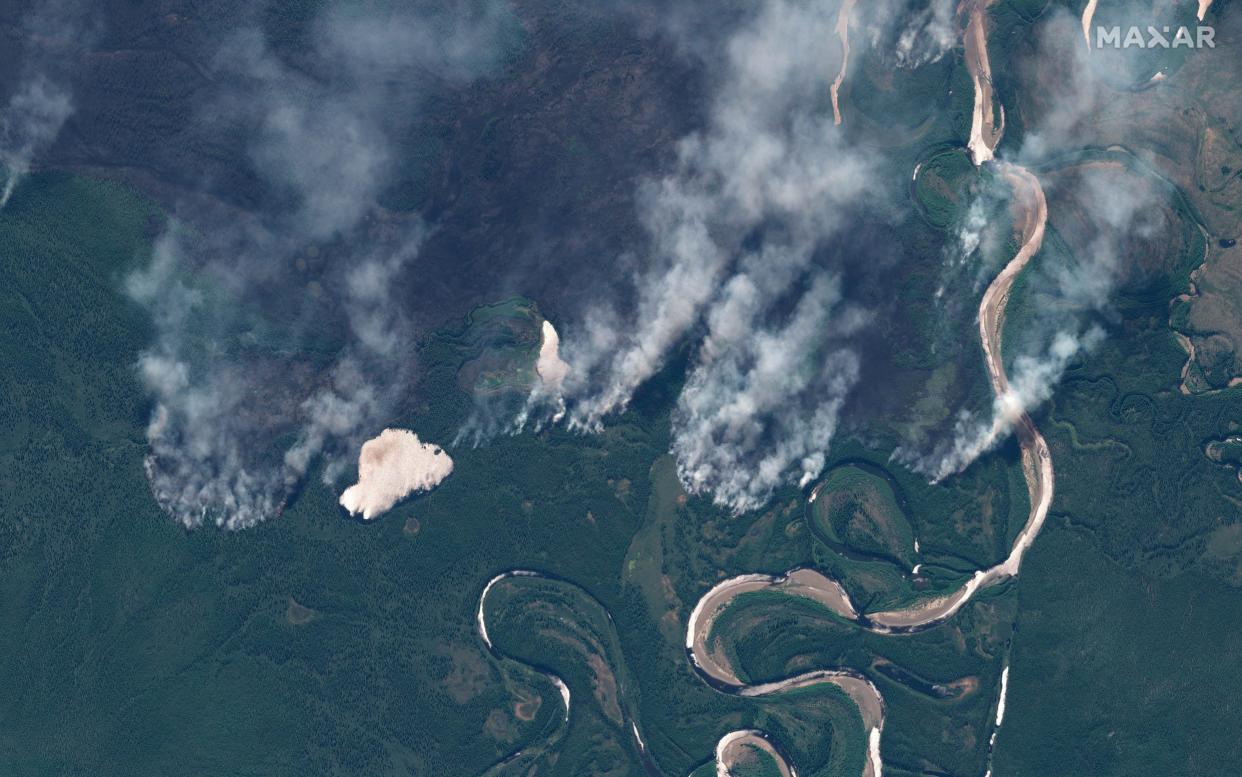 Smoke rises from wildfires near Berezovka River in the Russian republic of Altai, western Siberia, in this June 23, 2020 - Maxar Technologies via REUTERS
