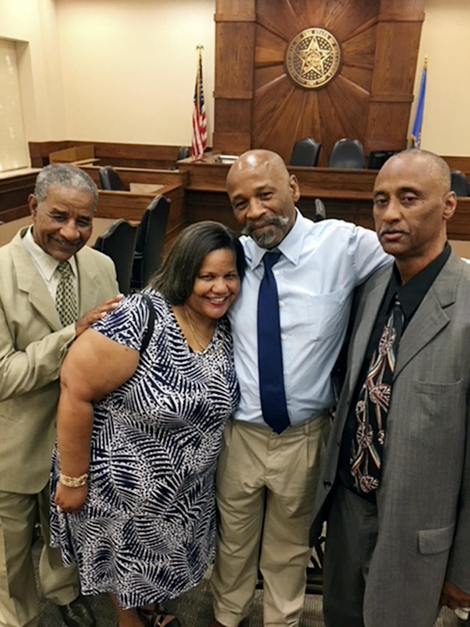 FILE - This photo provided by the Innocence Project shows Perry Lott, second from right, inside a courtroom in Oklahoma City, July 9, 2018, with his brother Steve Lott, left; sister Tammy Lott, center; and brother Willie Lott, right; after being freed from prison when the Innocence Project presented DNA evidence it says excluded him from the crime. An Oklahoma judge on Tuesday, Oct. 10, 2023, exonerated Lott, who spent 30 years in prison for a 1987 rape and burglary, after post-conviction DNA testing from a rape kit showed he did not commit the crime. (Karen Thompson/Innocence Project via AP, File)