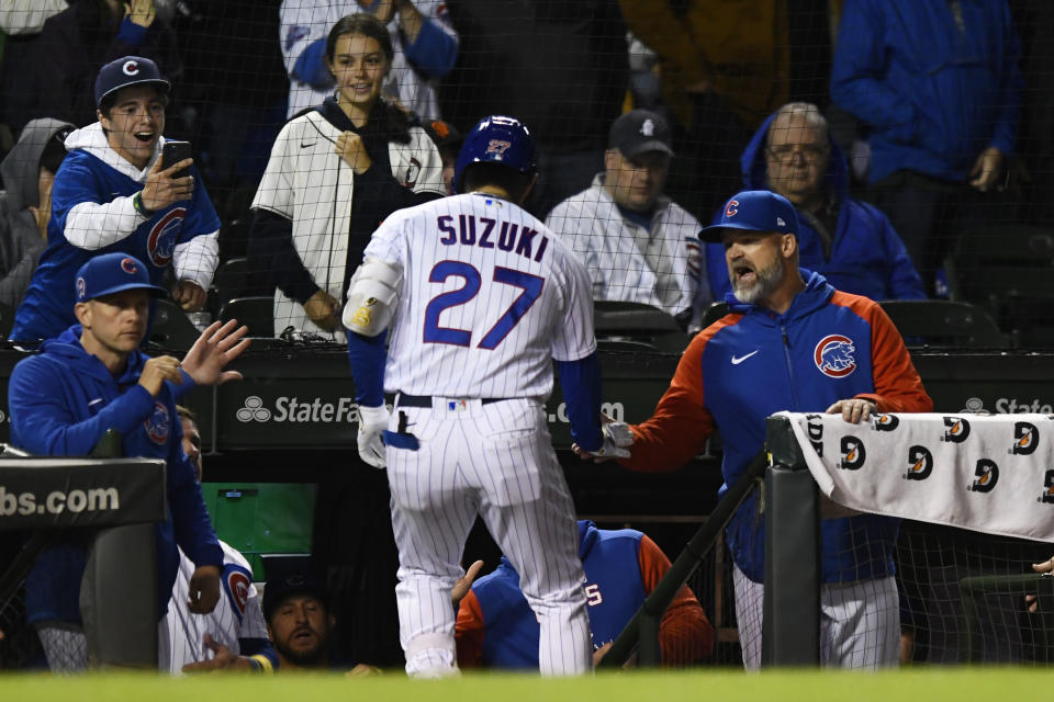 Chicago Cubs' Seiya Suzuki (27) celebrates with manager Davis Ross, right, at the dugout after hitting a solo home run during the eighth inning of a baseball game against the San Francisco Giants Sunday, Sept. 11, 2022, in Chicago. (AP Photo/Paul Beaty)