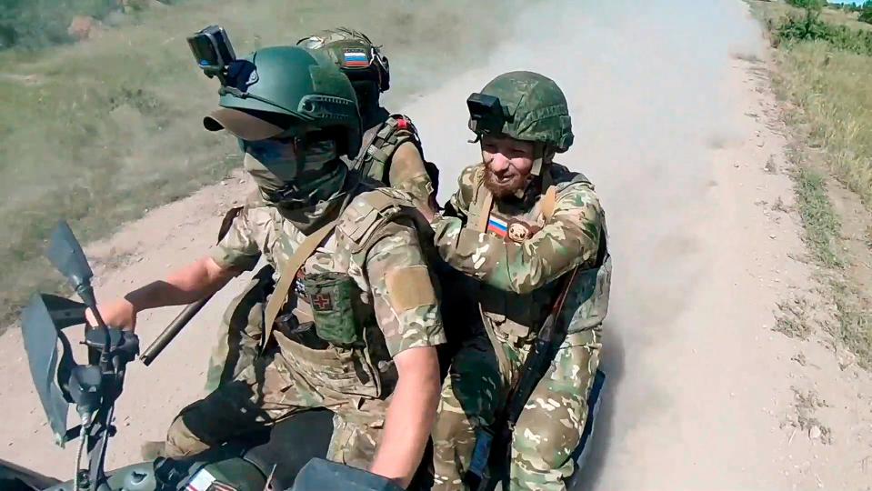 In this photo, taken from video released by the Russian Defense Ministry Press Service on Monday, July 1, 2024, Russian soldiers ride a quad bike changing their positions at the frontline in an undisclosed location in Ukraine (AP)