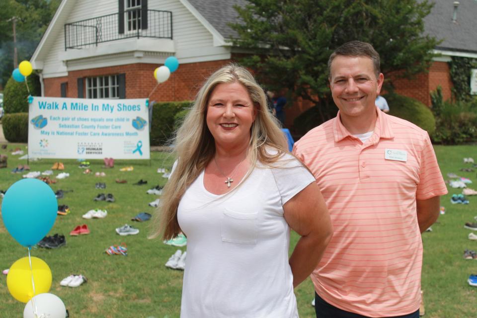 Sarah Sharum, area director for Arkansas Division of Children and Family Services, left, and Matt Whitson, executive director of Arkansas Family Alliance, helped distribute more than 400 pairs of donated new and lightly-worn shoes for foster children during the 2022 "Walk a Mile in My Shoes" effort.