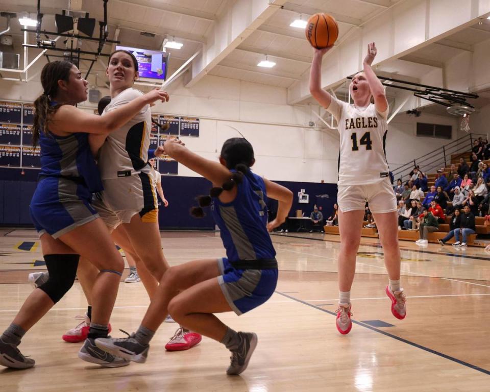 Ellie Sloan shoots behind a screen from Diana Sorrondo as Arroyo Grande fell to Caruthers 51-36 in a high school girls basketball playoff on Feb. 14, 2024. David Middlecamp/dmiddlecamp@thetribunenews.com