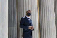 Greece's Prime Minister Kyriakos Mitsotakis waits to welcome the leaders of Cyprus and Jordan ahead of a meeting, in Athens, on Wednesday, July 28, 2021. Greece is hosting a one-day trilateral meeting of the three leaders. (AP Photo/Yorgos Karahalis)