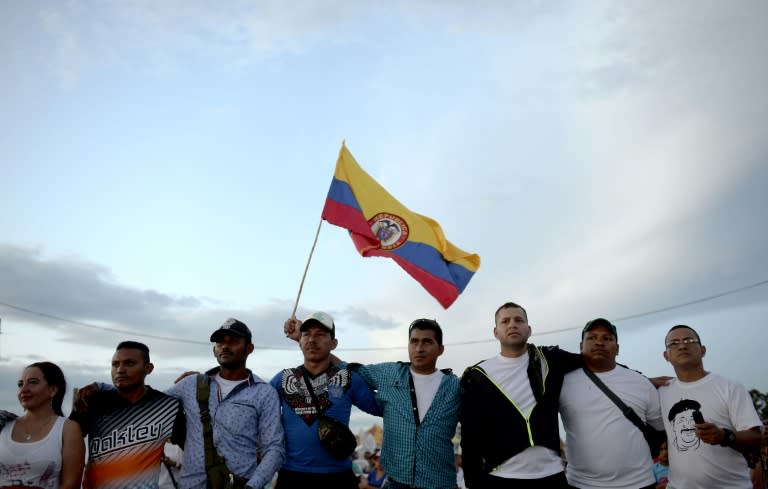 Members of the Colombian Revolutionary Armed Forces of Colombia (FARC) guerrilla attend the broadcasting of the signing of the peace at El Diamante rebel camp, Caqueta department, Colombia