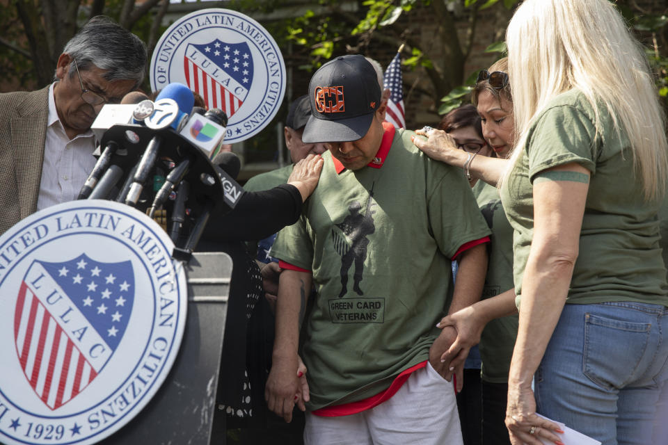 United States Army veteran Miguel Perez Jr. receives a blessing by friends and family at a news conference Tuesday, Sept. 24, 2019, at Lincoln Methodist Church in Chicago. Perez, an Army veteran who was deported to Mexico in 2018, arrived back in Chicago Tuesday for a final chance at becoming a U.S. citizen and living in the city he has called home since boyhood. (Erin Hooley/Chicago Tribune via AP)