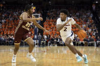 Virginia's Reece Beekman (2) drives past Boston College's Devin McGlockton (21) during the second half of an NCAA college basketball game in Charlottesville, Va., Saturday, Jan. 28, 2023. (AP Photo/Mike Kropf)