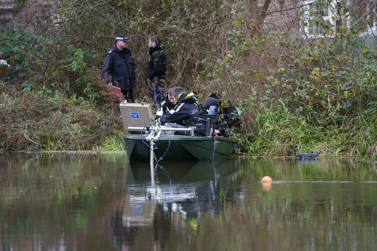 Officers were seen marking out a specific part of the water with an orange buoy earlier in the morning and divers later pulled a body out of the water nearby (PA)