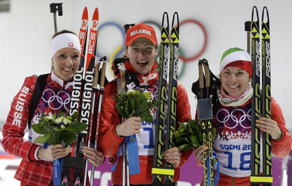 Silver medalist Switzerland's Selina Gasparin, left, gold medalist Belarus' Darya Domracheva, center, and bronze medalist Belarus' Nadezhda Skardino pose after the women's biathlon 15k individual race, at the 2014 Winter Olympics, Friday, Feb. 14, 2014, in Krasnaya Polyana, Russia. (AP Photo/Lee Jin-man)