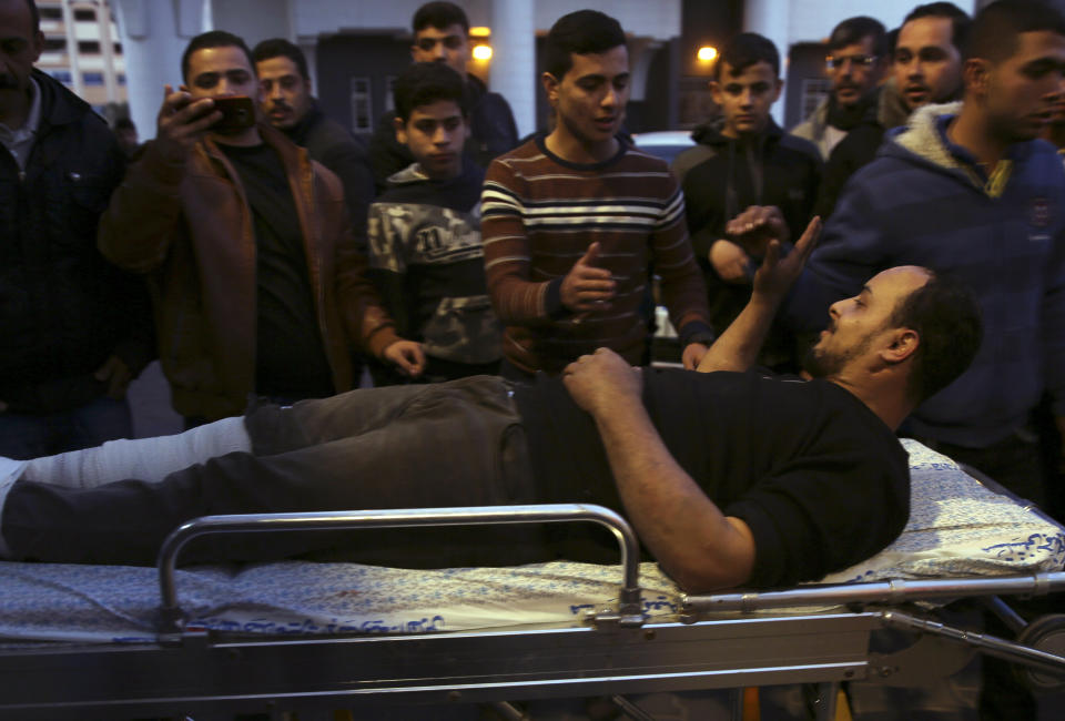 Medics move a wounded youth, who was shot by Israeli troops during a protest at the Gaza Strip's border with Israel, into the treatment room of Shifa hospital in Gaza City, Friday, March 8, 2019. (AP Photo/Adel Hana)