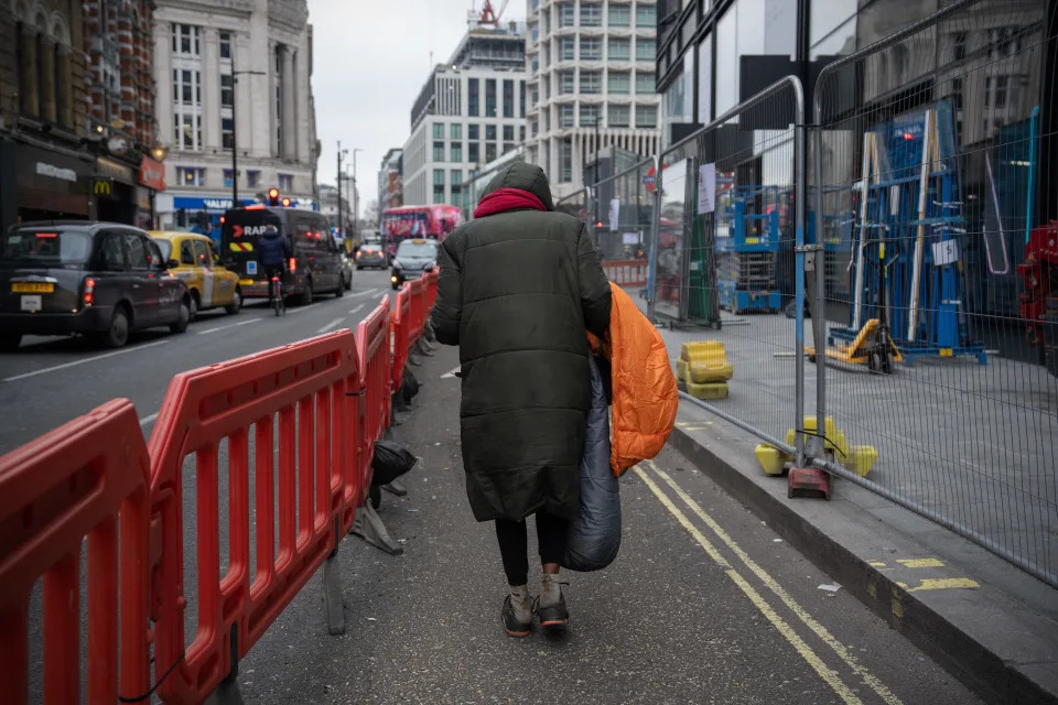 LONDON, ENGLAND - JANUARY 24: A homeless woman carries a sleeping bag as she walks along Oxford Street on January 24, 2023 in London, United Kingdom. With the 2023 Rowntree report on poverty due to be published later this week, last year&#39;s report found more than one in five of the UK population was living in poverty. Homeless charity Shelter recently stated that one in 58 Londoners is homeless, far higher than the national figure of one in 208. This is, in part, due to the chronic shortage of affordable housing in the capital. In 2022 around 271,000 people were homeless on any given night across the UK, Shelter estimates that almost half of them are children. (Photo by Carl Court/Getty Images)