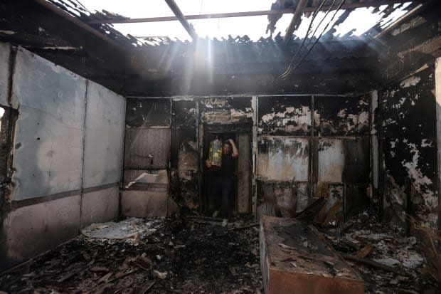 Torah scrolls, Jewish holy scriptures, are removed on May 12 from a synagogue that was torched during violent confrontations in Lod between Arab-Israeli demonstrators and police.