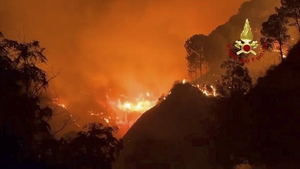This picture released by the Italian firefighters shows wildfires in the region of Palermo in Sicily, Italy, Tuesday July 25, 2023. (Italian Firefighters - Vigili del Fuoco via AP)