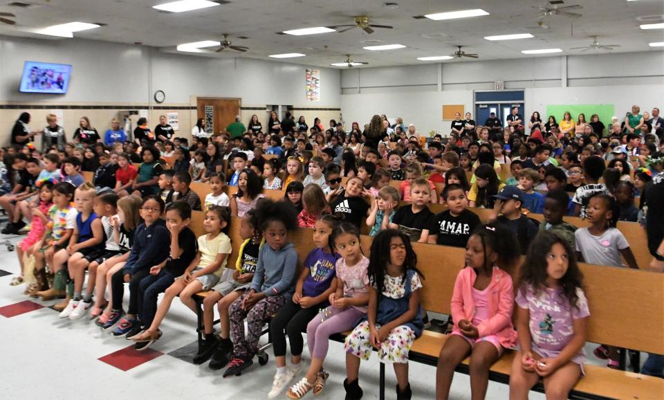 Lamar Elementary School students sit in attendance for the flag lowering ceremony on Thursday, May 25, 2023.