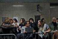 Reporters and members of the public who are at the front of the line to enter the courtroom to listen to the case against film producer Harvey Weinstein stand at New York Criminal Court during the sexual assault trial in the Manhattan borough of New York C