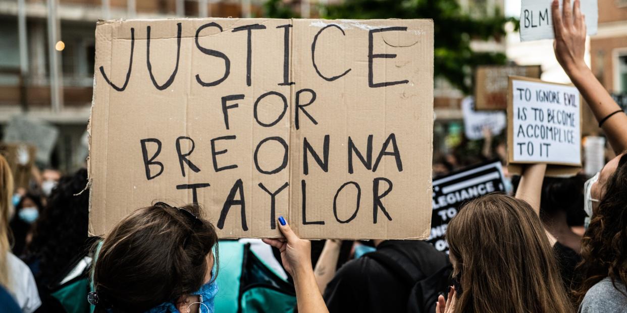 A girl holding a sign asking justice for Breonna Taylor demonstrating in Mestre, Venice, Italy on June 6, 2020