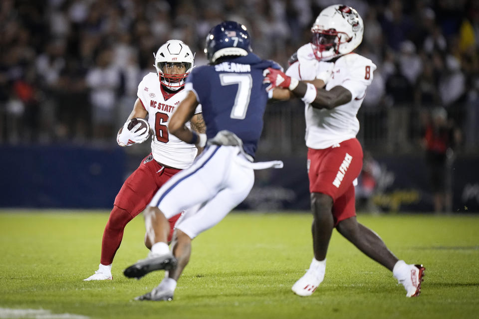 North Carolina State tight end Trent Pennix (6) runs with the ball during the first half the team's NCAA college football game against UConn in East Hartford, Conn., Thursday, Aug. 31, 2023. (AP Photo/Bryan Woolston)
