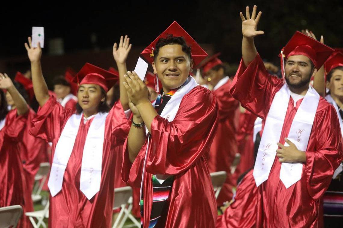 Graduates applaud their parents during the McLane High graduation at the school stadium on June 6, 2023.