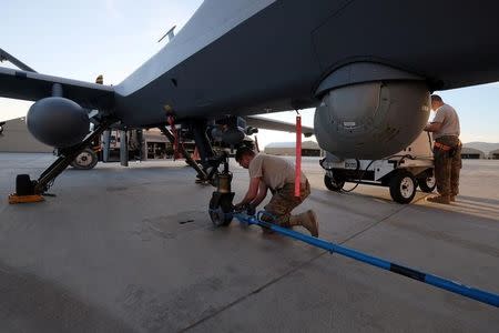 A U.S. airman secures an MQ-9 Reaper drone after it returned from a mission at Kandahar Air Field in Afghanistan March 9, 2016. REUTERS/Josh Smith/Files