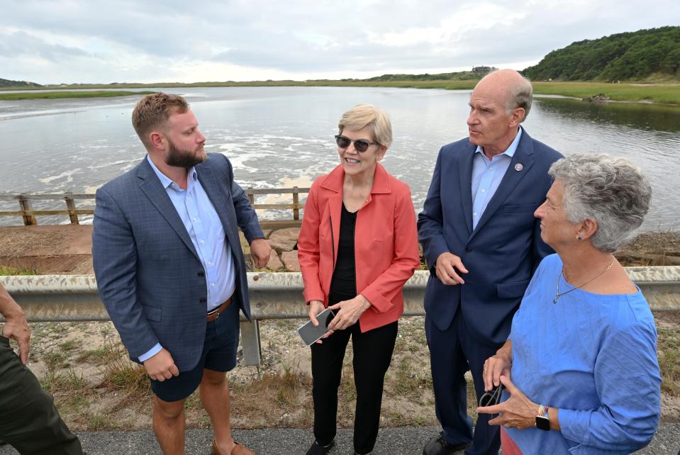 Sen. Elizabeth Warren (center) joins Congressman William R. "Bill" Keating, D-Mass, and state Sen. Julian Cyr, D-Truro and state Rep. Sarah Peake, D-Provincetown on the Chequessett Neck Road Bridge in Wellfleet for a visual of the Herring River Restoration Project Tuesday afternoon.