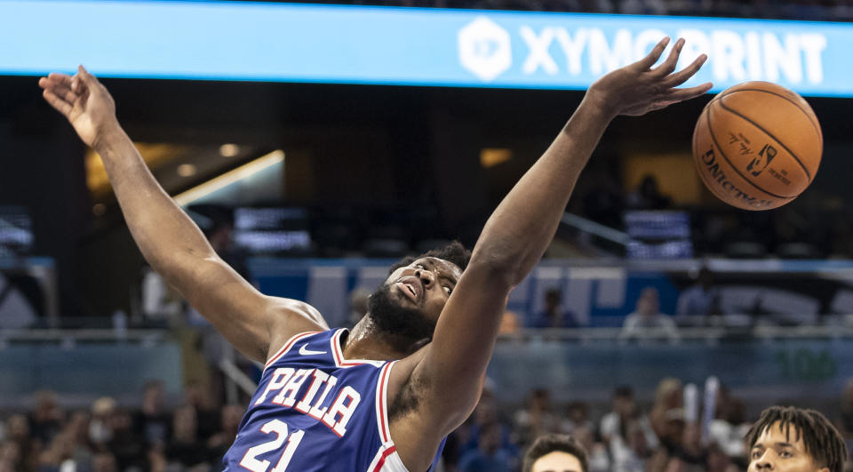 Philadelphia 76ers center Joel Embiid (21) tries to rebound the ball during the first half of a preseason NBA basketball game against Orlando Magic in Orlando, Fla., Sunday, Oct. 13, 2019. (AP Photo/Willie J. Allen Jr.)