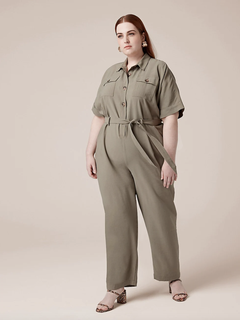 red head plus size model in tan belted jumpsuit and sandals