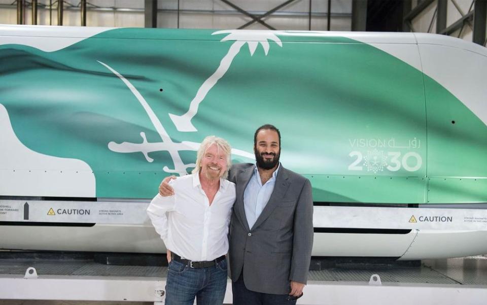 Richard Branson and Crown Prince of Saudi Arabia Mohammed bin Salman Al Saud pose for a photo at the Virgin Galactic company in California, April 2, 2018. Saudi Arabia is investing $1 billion in the company.