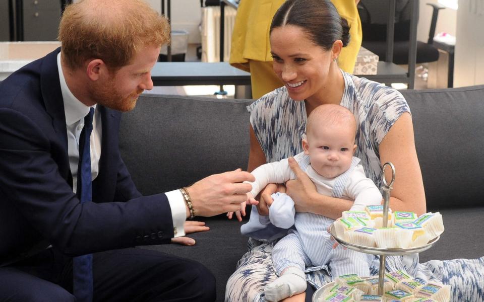 The Duke and Duchess of Sussex hold their baby son Archie in 2019 - Henk Kruger/AFP