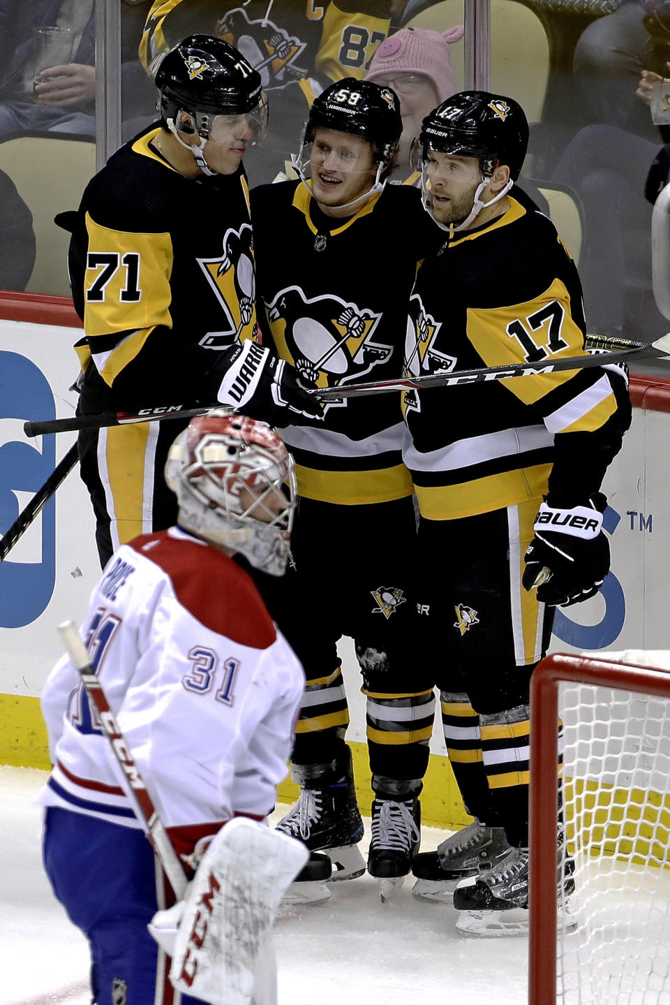 Pittsburgh Penguins' Jake Guentzel (59) celebrates his goal with Evgeni Malkin (71) and Bryan Rust (17) as Montreal Canadiens goaltender Carey Price (31) collects himself during the first period of an NHL hockey game in Pittsburgh, Tuesday, Dec. 10, 2019. (AP Photo/Gene J. Puskar)