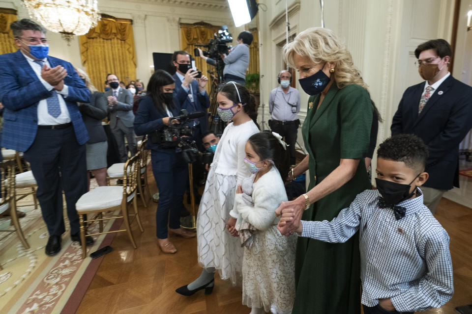 First lady Jill Biden, third from right, walks in the East Room with little caregivers, fifth from right to right, Gabby and Eva Rodriguez, and Mason, during a ceremony at the White House honoring children in military and veteran caregiving families, Wednesday, Nov. 10, 2021. (AP Photo/Manuel Balce Ceneta)