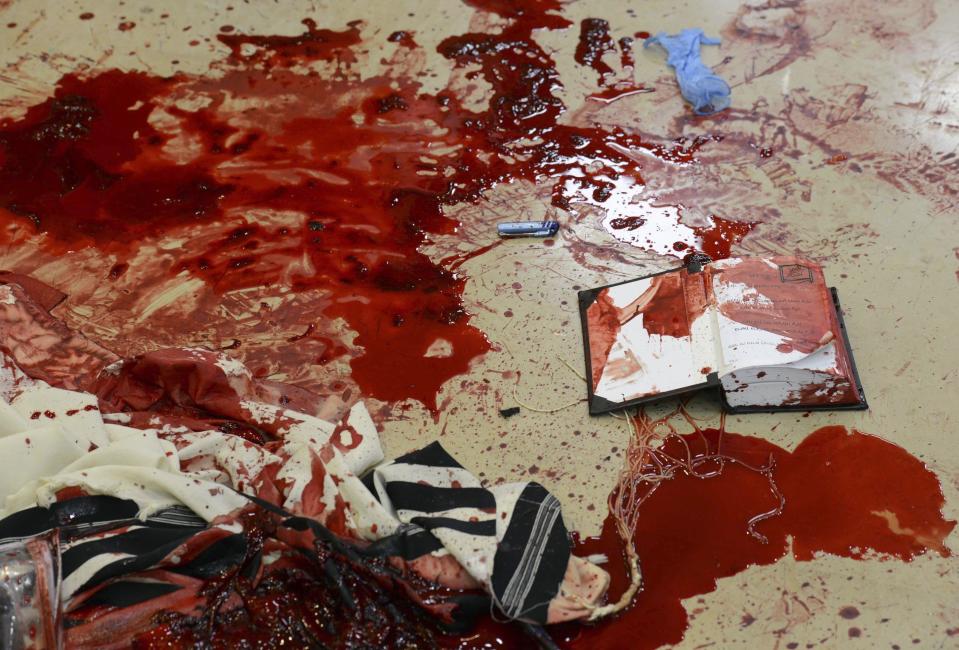 Handout photo of pools of blood seen near a religious Jewish text at the scene of an attack at a Jerusalem synagogue