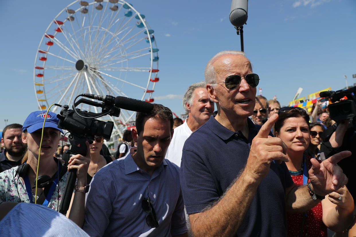 Former Vice President Joe Biden is surrounded by journalists as he heads for the exits at the Iowa State Fair in Des Moines on Thursday. (Photo by Chip Somodevilla/Getty Images)