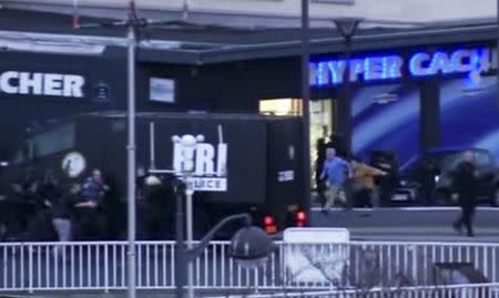 Hostages fleeing from a kosher supermarket as French police special forces launch their assault after several people were taken hostage near the Porte de Vincennes in eastern Paris, January 9, 2015. REUTERS/BFMTV via Reuters TV