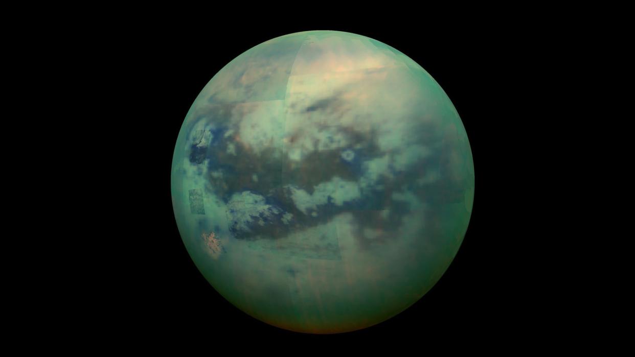  A green moon with streaks and pools of darker green on its surface. 