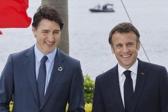 Canada's Prime Minister Justin Trudeau, left, and France's President Emmanuel Macron participate in a family photo with G7 leaders before their working lunch meeting on economic security during the G7 summit, at the Grand Prince Hotel in Hiroshima, western Japan Saturday, May 20, 2023. (Jonathan Ernst/Pool Photo via AP)